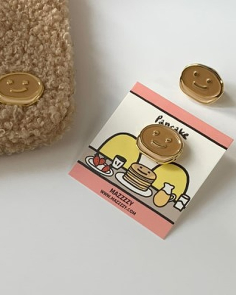 "meta_description": "Trendy pancake badge that changes with the light. Perfect unique accessory!",