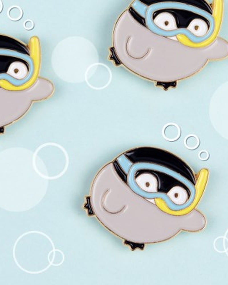 "meta_description": "Discover the Koupenchan badge, a charming gold pin featuring a gentle baby penguin.",