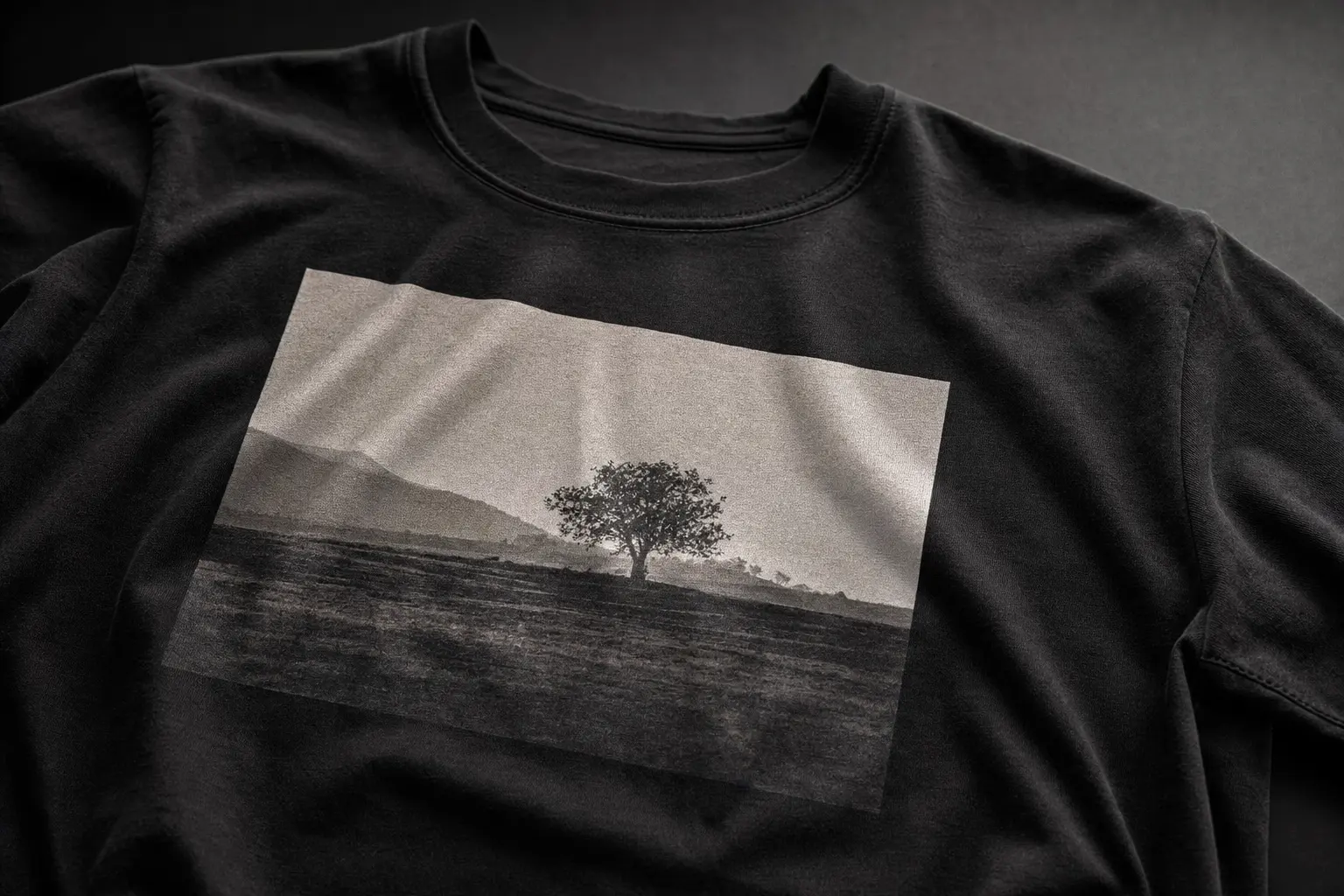 A close-up studio shot of a Bella+Canvas 3001 cotton tee laid flat: show the combed cotton texture, a high-resolution DT