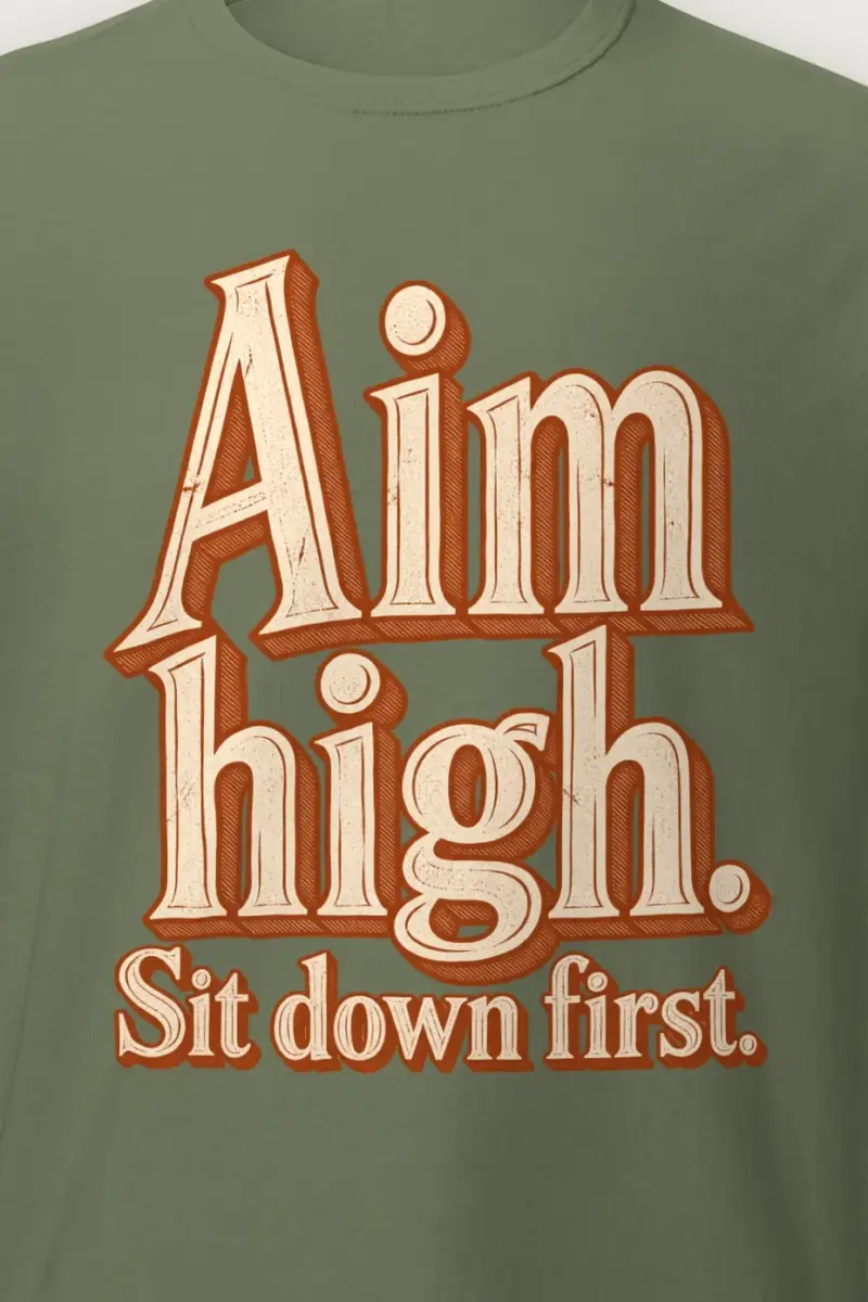 "Aim High. Sit Down First." Heavyweight Unisex Crewneck T-shirt - the graphic up close