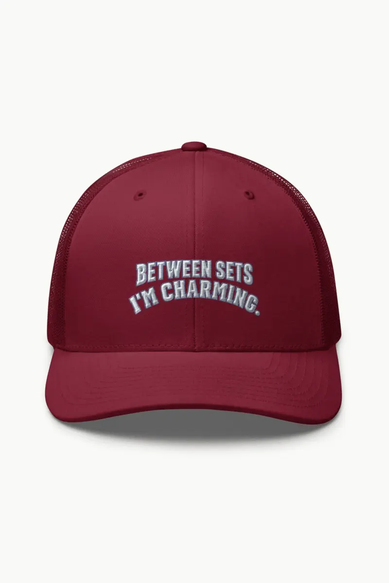 “Between Sets I’m Charming” Retro Trucker Cap · Embroidered