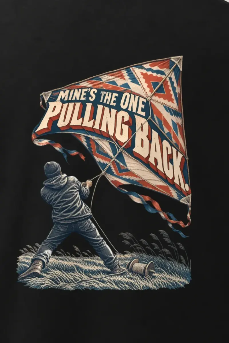 "Mine’s the One Pulling Back" Men’s Oversized Heavyweight Crewneck T-Shirt - the graphic up close