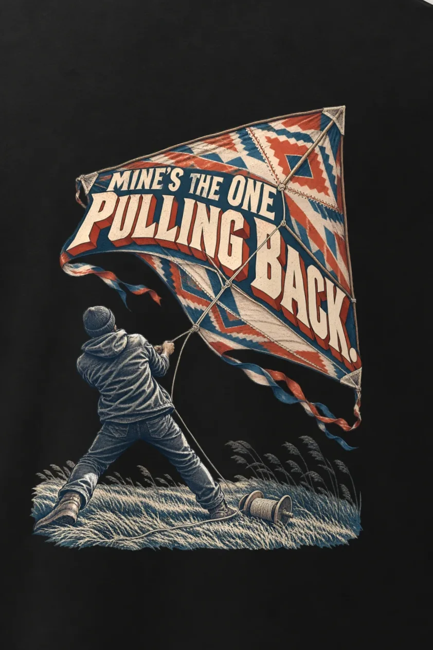 "Mine’s the One Pulling Back" Men’s Oversized Heavyweight Crewneck T-Shirt - the graphic up close