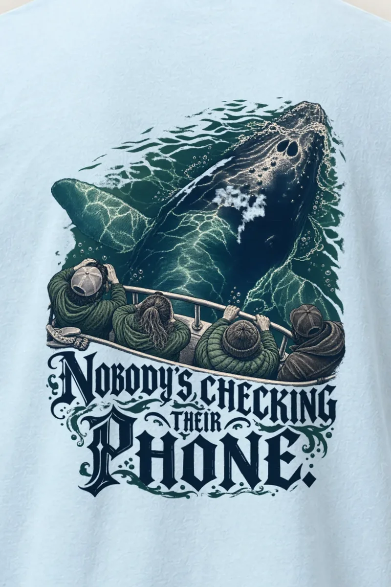 "Nobody’s Checking Their Phone" Heavyweight Unisex Crewneck T-shirt - the graphic up close