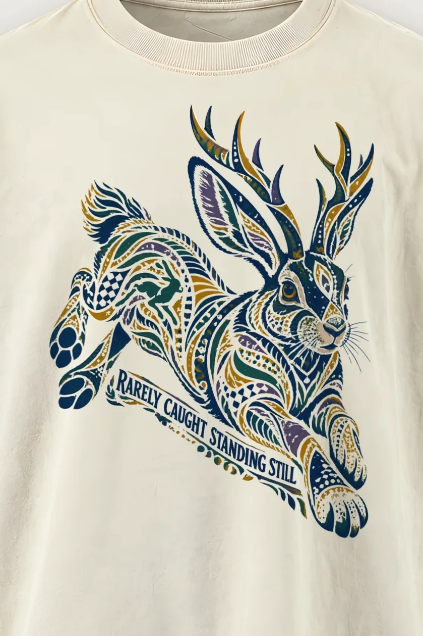 "Rarely Caught Standing Still" Men’s Oversized Heavyweight Crewneck T-Shirt - the graphic up close