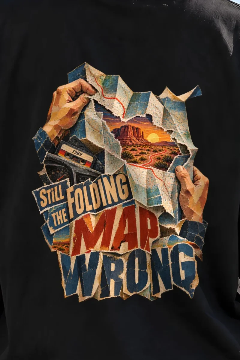 "Still Folding the Map Wrong" Unisex Oversized Heavyweight Crewneck T-Shirt - the graphic up close