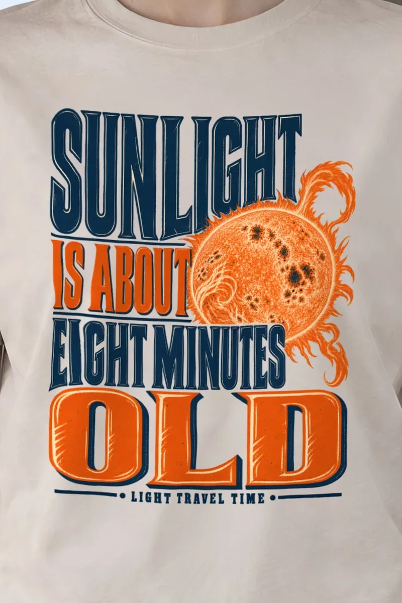 "Sunlight Is About Eight Minutes Old" Heavyweight Unisex Crewneck T-shirt - the graphic up close