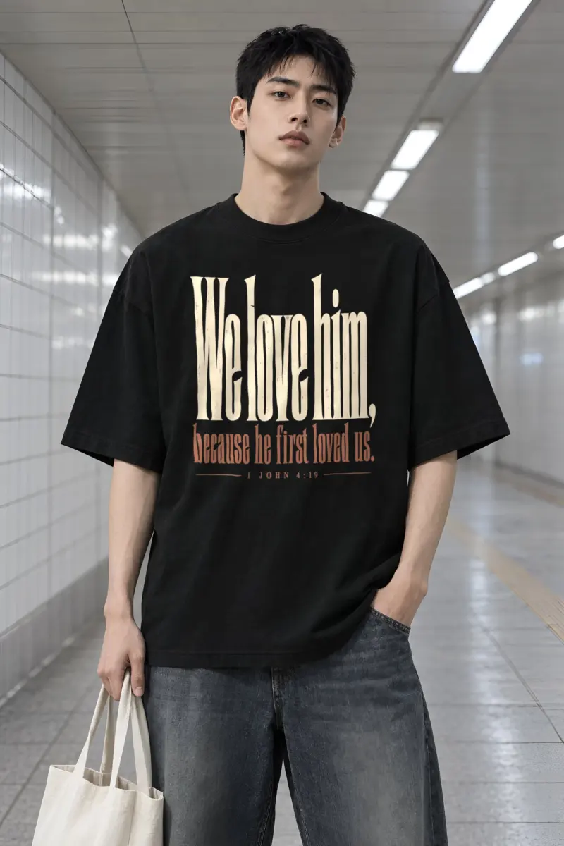 "We Love Him, Because He First Loved Us." Men's Oversized Heavyweight Crewneck T-Shirt