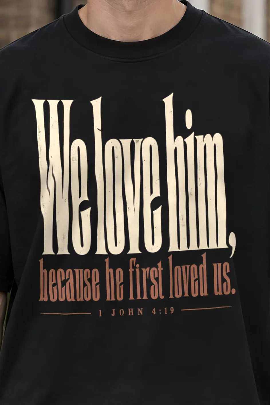 "We Love Him, Because He First Loved Us." Men’s Oversized Heavyweight Crewneck T-Shirt - the graphic up close