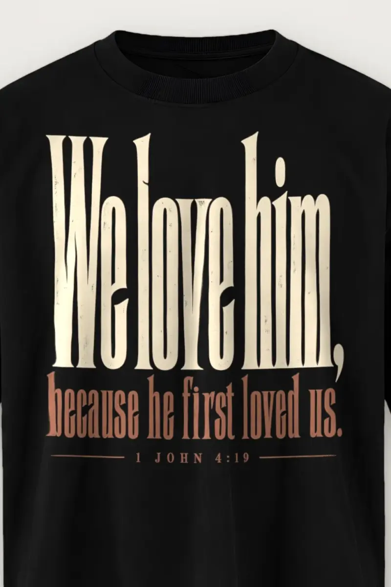 "We Love Him, Because He First Loved Us." Men’s Oversized Heavyweight Crewneck T-Shirt - the graphic up close